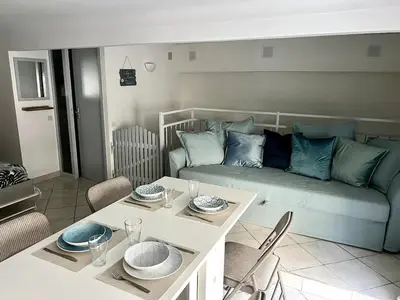 a living room with a couch and a table at Cozy apartement near the beach with with Aircon in Nice