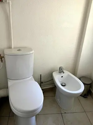 a white toilet and a sink in a bathroom at Cozy apartement near the beach with with Aircon in Nice