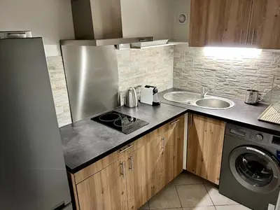 a small kitchen with a sink and a refrigerator at Cozy apartement near the beach with with Aircon in Nice