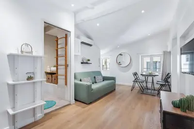 a living room with a green couch and a table at Nice Renting - 6B FRANCE - Massena beach design AC quiet center wifi in Nice