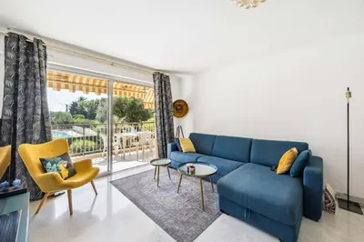 a living room with a blue couch and yellow chairs at Happyfew La Suite Nicerama in Nice