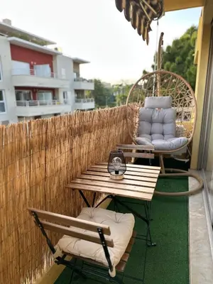 a patio with a bench and a table and chairs at Sun, beach and relaxation in Cagnes-sur-Mer