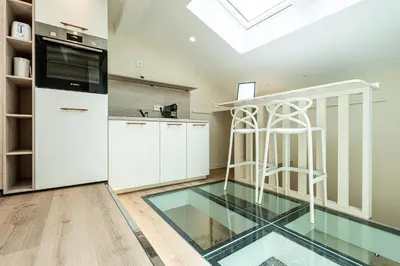 a kitchen with glass floors and a skylight at La Vila-Vielha in Nice