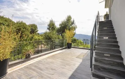 a balcony with stairs and a view of the water at Exceptional Villa with Sea View, Pool & Privacy in Gattières