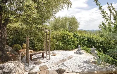 a garden with a gate and a bench and trees at Exceptional Villa with Sea View, Pool & Privacy in Gattières