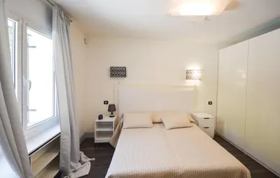 a white bedroom with a bed and a window at Exceptional Villa with Sea View, Pool & Privacy in Gattières