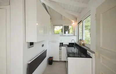 a kitchen with white cabinets and a sink at Exceptional Villa with Sea View, Pool & Privacy in Gattières