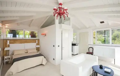a bedroom with a bed and a chandelier at Exceptional Villa with Sea View, Pool & Privacy in Gattières