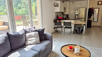 a living room with a couch and a table at T4 avec grande terrasse - BBQ - parking in La Trinité