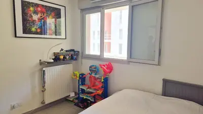 a bedroom with a bed and a window at T4 avec grande terrasse - BBQ - parking in La Trinité