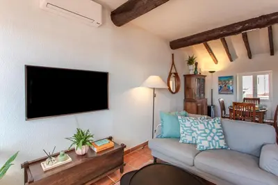 a living room with a couch and a flat screen tv at #50 Contesso Duplex -1BDR, Sea View Terrace & AC in Villefranche-sur-Mer