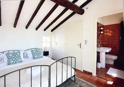 a bedroom with a bed and a bathroom at #50 Contesso Duplex -1BDR, Sea View Terrace & AC in Villefranche-sur-Mer