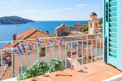 a balcony with a view of the ocean at #50 Contesso Duplex -1BDR, Sea View Terrace & AC in Villefranche-sur-Mer