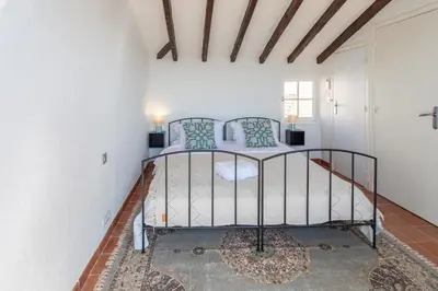 a bedroom with a metal bed in a room at #50 Contesso Duplex -1BDR, Sea View Terrace & AC in Villefranche-sur-Mer