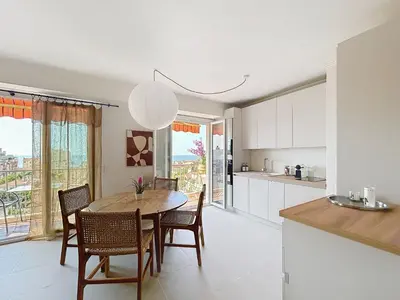 a kitchen and dining room with a table and chairs at Azur in Cagnes-sur-Mer