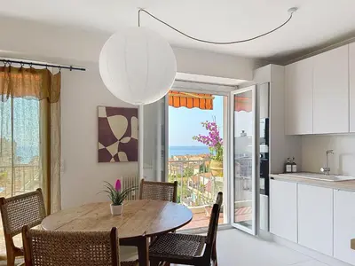 a kitchen and dining room with a table and chairs at Azur in Cagnes-sur-Mer