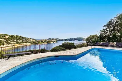 a swimming pool with a view of a body of water at Magnifique appartement avec vue mer époustouflante in Villefranche-sur-Mer