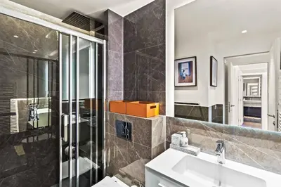 a bathroom with a sink and a mirror at Magnifique appartement avec vue mer époustouflante in Villefranche-sur-Mer