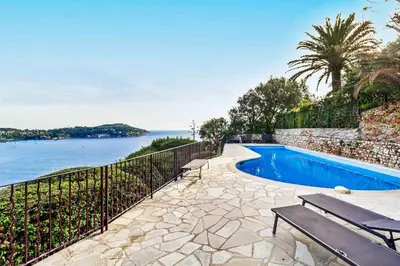 a swimming pool with a view of the water at Magnifique appartement avec vue mer époustouflante in Villefranche-sur-Mer