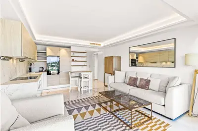 a living room with a couch and a table at Magnifique appartement avec vue mer époustouflante in Villefranche-sur-Mer
