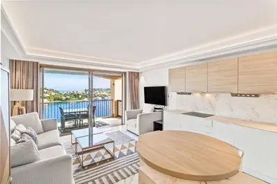 a living room with a couch and a table at Magnifique appartement avec vue mer époustouflante in Villefranche-sur-Mer