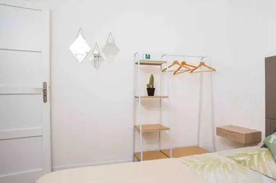 a bedroom with a bed and a closet with a shelf at Perle de Nice - 50 mètres de la plage, Clim, Wifi in Nice