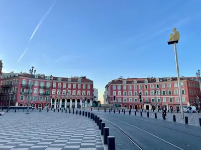 a city street with red buildings in the background at Perle de Nice - 50 mètres de la plage, Clim, Wifi in Nice