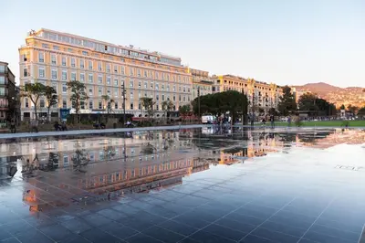 a large building is reflected in a large pool of water at 1 bedroom, Best location in Nice in Nice