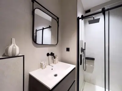 a bathroom with a sink and a mirror and a shower at Appartement Niçois - 3 Pièces au Centre in Nice
