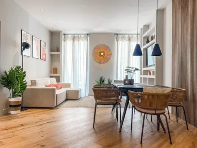 a living room with a table and chairs at Appartement Niçois - 3 Pièces au Centre in Nice