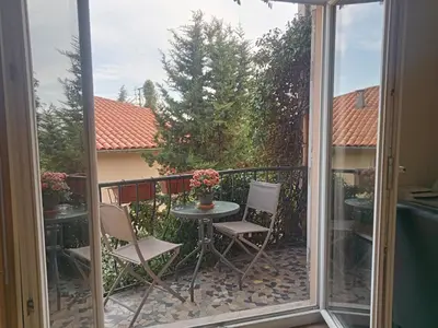 a staircase with wooden steps and a metal railing at Family villa 10 minutes from Nice beaches in Nice