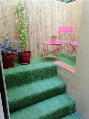 a green staircase with potted plants and a pink table at Studio in the heart of Nice in Nice