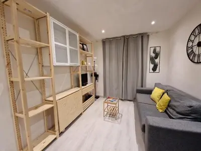 a living room with a couch and a book shelf at Studio in the heart of Nice in Nice