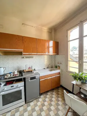 a kitchen with wooden cabinets and a sink and a stove at 5 sky miniPenthouse in Nice
