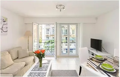 a living room with a couch and a table at 2 pièces centre ville-Balcon in Nice
