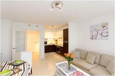 a living room with a white couch and a table at 2 pièces centre ville-Balcon in Nice
