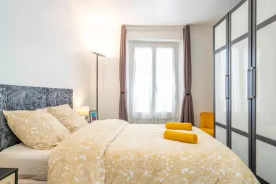 a bedroom with a bed with a yellow object on it at Modern and elegant, air-conditioned, city centre - HDP2 in Nice