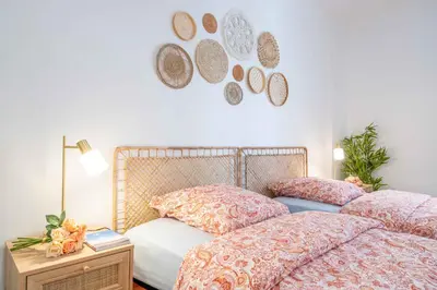 a bedroom with two beds with pink comforters and a table at Modern and elegant, air-conditioned, city centre - HDP2 in Nice