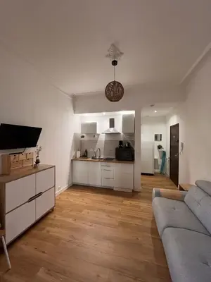 a living room with a couch and a kitchen at Simply the best! All you need! in Nice