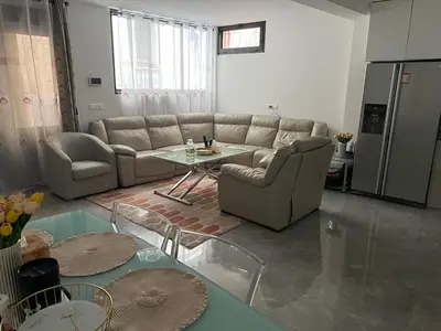 a living room with a couch and a table at Cosmina Residence in Nice