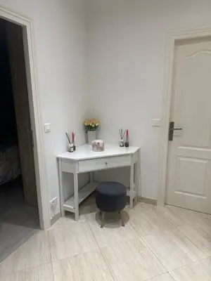 a white desk with a blue stool and a chair at Cosmina Residence in Nice