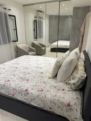 a bedroom with a large bed with pink flowers on it at Cosmina Residence in Nice