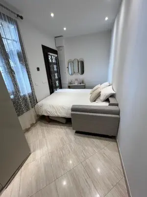 a small bedroom with a bed and a window at Cosmina Residence in Nice
