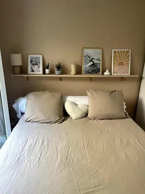 a bedroom with a bed with two pillows at Appartement calme vue mer in Saint-Laurent-du-Var