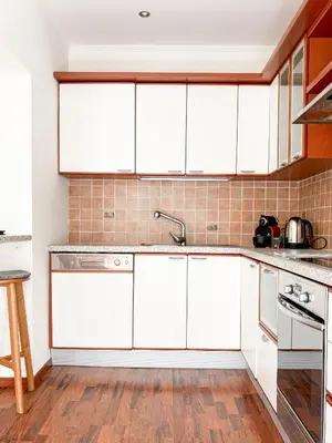 a kitchen with white cabinets and a sink at Hyper-centre, Air-conditioned apartment with balcony in Nice