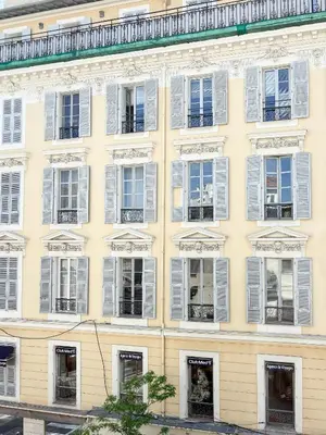 a large yellow building with white windows at Hyper-centre, Air-conditioned apartment with balcony in Nice