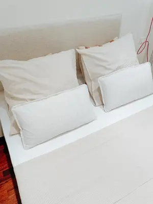 a white bed with white pillows on it at Hyper-centre, Air-conditioned apartment with balcony in Nice