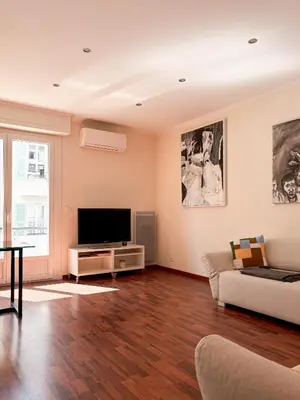a living room with a couch and a flat screen tv at Hyper-centre, Air-conditioned apartment with balcony in Nice