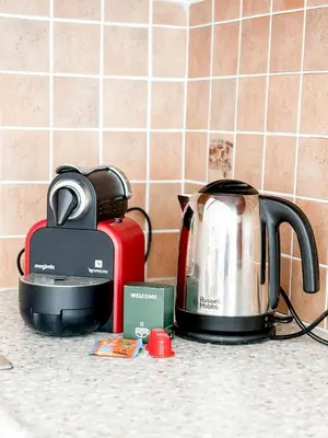 a kitchen counter with a coffee maker and a tea kettle at Hyper-centre, Air-conditioned apartment with balcony in Nice