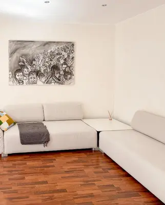 a white couch in a room with a painting on the wall at Hyper-centre, Air-conditioned apartment with balcony in Nice